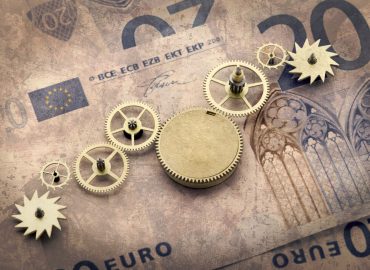 Gear wheels on dollar bill revealing the path to success